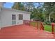 Spacious red painted back deck with mature tree views and access door to the house at 3830 Waters Reach Ln, Indian Trail, NC 28079