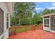 Overlooking a lush backyard, this spacious red painted back deck includes access to the screened porch at 3830 Waters Reach Ln, Indian Trail, NC 28079