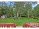 View from back deck stairs onto lush backyard with shed, trees, and fire pit at 3830 Waters Reach Ln, Indian Trail, NC 28079