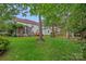 Expansive backyard with red painted fence, deck, screened porch, and plentiful shade at 3830 Waters Reach Ln, Indian Trail, NC 28079