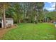 The backyard is expansive and features a hammock, storage shed, and mature shade trees at 3830 Waters Reach Ln, Indian Trail, NC 28079