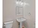 Half bath with pedestal sink, white fixtures, and neutral wall color at 3830 Waters Reach Ln, Indian Trail, NC 28079