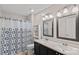 Bright bathroom featuring a dual sink vanity, a large mirror, and a shower/tub with a decorative curtain at 3830 Waters Reach Ln, Indian Trail, NC 28079