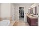Bathroom featuring a vanity, shower, soaking tub, and large walk-in closet at 3830 Waters Reach Ln, Indian Trail, NC 28079