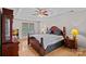 Bedroom with tray ceilings, hardwood floors, and plenty of natural light at 3830 Waters Reach Ln, Indian Trail, NC 28079