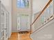 Bright foyer featuring hardwood floors, high ceilings, and a staircase at 3830 Waters Reach Ln, Indian Trail, NC 28079