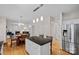 Open kitchen with granite counters, island seating, and stainless steel appliances at 3830 Waters Reach Ln, Indian Trail, NC 28079