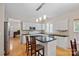 The kitchen features white cabinetry, stainless appliances, granite countertops, and an island at 3830 Waters Reach Ln, Indian Trail, NC 28079