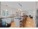 Bright kitchen featuring an island, white cabinets, stainless-steel appliances, and hardwood floors at 3830 Waters Reach Ln, Indian Trail, NC 28079