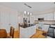Bright kitchen features white cabinetry, stainless appliances, and a large island with bar seating at 3830 Waters Reach Ln, Indian Trail, NC 28079