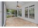 The tiled floor screened porch features an ceiling fan, windows, and exterior views at 3830 Waters Reach Ln, Indian Trail, NC 28079