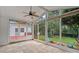 View from screened porch with tiled floor onto back deck and backyard with fire pit at 3830 Waters Reach Ln, Indian Trail, NC 28079