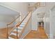 Elegant staircase with hardwood floors and white railings at 3830 Waters Reach Ln, Indian Trail, NC 28079