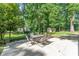 Outdoor patio featuring an outdoor dining table in a serene, wooded setting at 4014 Sulkirk Rd, Charlotte, NC 28210