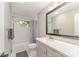 Updated bathroom with a shower-tub combo, complemented by modern fixtures and neutral tones at 4014 Sulkirk Rd, Charlotte, NC 28210