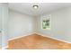 Clean bedroom with hardwood floors and natural light streaming through the window at 4014 Sulkirk Rd, Charlotte, NC 28210