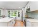 Bright and modern kitchen with stainless steel appliances, quartz countertops and a large window at 4014 Sulkirk Rd, Charlotte, NC 28210