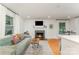 Cozy living room with a fireplace, comfortable seating, and plenty of natural light at 4014 Sulkirk Rd, Charlotte, NC 28210