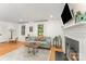 Bright living room with a fireplace, hardwood floors, and large windows at 4014 Sulkirk Rd, Charlotte, NC 28210