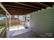 Covered back porch featuring wood ceiling, railing, and siding, creating an inviting outdoor living space at 405 E 18Th St, Kannapolis, NC 28083