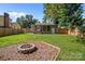 Backyard with a fire pit, shed, and a well-maintained lawn creating a pleasant outdoor space for relaxation at 405 E 18Th St, Kannapolis, NC 28083