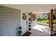Close up of the porch featuring decorative plants, wood columns, and a wreath at 405 E 18Th St, Kannapolis, NC 28083
