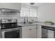 Bright kitchen features stainless steel appliances, subway tile backsplash and granite countertops at 405 E 18Th St, Kannapolis, NC 28083