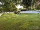 A backyard with a white fence surrounding the perimeter and a playground in the back at 407 W Mill St, Landis, NC 28088