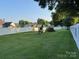 A backyard with a white fence surrounding the perimeter and a playground in the back at 407 W Mill St, Landis, NC 28088
