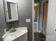 Modest bathroom featuring a corner sink and medicine cabinet at 407 W Mill St, Landis, NC 28088