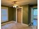 Bedroom with carpet, ceiling fan, closet and view into kitchen and front of house at 407 W Mill St, Landis, NC 28088