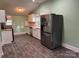Kitchen view showcasing stainless steel refrigerator and white cabinets at 407 W Mill St, Landis, NC 28088