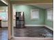 Open-concept living area showcasing stylish wood-look floors and stainless steel refrigerator at 407 W Mill St, Landis, NC 28088