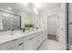 Modern bathroom featuring double sinks, sleek fixtures, and a glass-enclosed shower at 411 Devender Ne Ln # 5, Charlotte, NC 28217