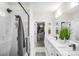 Bright bathroom with a double sink vanity, a walk-in shower, and an attached walk-in closet at 411 Devender Ne Ln # 5, Charlotte, NC 28217