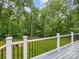 Enjoy the serene backyard view from the deck, framed by lush trees and a well-maintained lawn at 5322 Bridgeview Dr, Iron Station, NC 28080