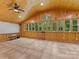 Large basement with wood-paneled walls, tiled floors, and floor to ceiling windows at 5322 Bridgeview Dr, Iron Station, NC 28080