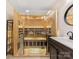 Bathroom featuring glass-enclosed sauna, wood accents, sleek vanity and modern lighting at 5322 Bridgeview Dr, Iron Station, NC 28080