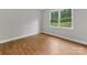 This bedroom has wood flooring and a large window at 5322 Bridgeview Dr, Iron Station, NC 28080