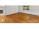 Bright bedroom with hardwood floors, neutral walls, and natural light from the windows at 5322 Bridgeview Dr, Iron Station, NC 28080