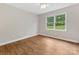 This bedroom has wood flooring and a large window at 5322 Bridgeview Dr, Iron Station, NC 28080