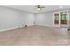 Spacious bonus room with tile floors and access to the backyard through glass doors at 5322 Bridgeview Dr, Iron Station, NC 28080