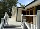 Spacious deck with modern railings leading into the house with wooden doors at 5322 Bridgeview Dr, Iron Station, NC 28080
