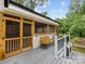 Inviting screened-in porch featuring a bench and charming wooden screen doors, perfect for enjoying outdoor living at 5322 Bridgeview Dr, Iron Station, NC 28080