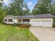 Charming home features a front porch, manicured lawn, and a two-car garage with driveway at 5322 Bridgeview Dr, Iron Station, NC 28080