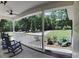 Inviting front porch featuring classic rocking chairs and a serene view of the yard at 5322 Bridgeview Dr, Iron Station, NC 28080
