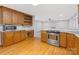 Kitchen featuring wooden cabinetry, stainless steel appliances and hardwood floors at 5322 Bridgeview Dr, Iron Station, NC 28080