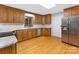 Functional kitchen featuring stainless steel appliances, white backsplash, and hardwood floors at 5322 Bridgeview Dr, Iron Station, NC 28080