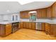 Well-lit kitchen featuring hardwood floors, stainless steel appliances and granite countertops at 5322 Bridgeview Dr, Iron Station, NC 28080