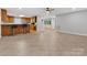 Inviting living room showcasing tile flooring connecting to the kitchen area at 5322 Bridgeview Dr, Iron Station, NC 28080